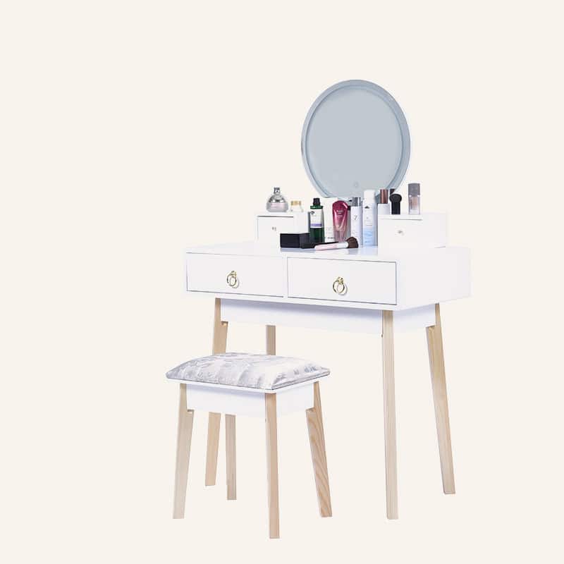 Dressing vanity table with LED mirror and makeup products in white and wood finish.