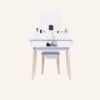 White dressing vanity table with LED mirror and makeup accessories.