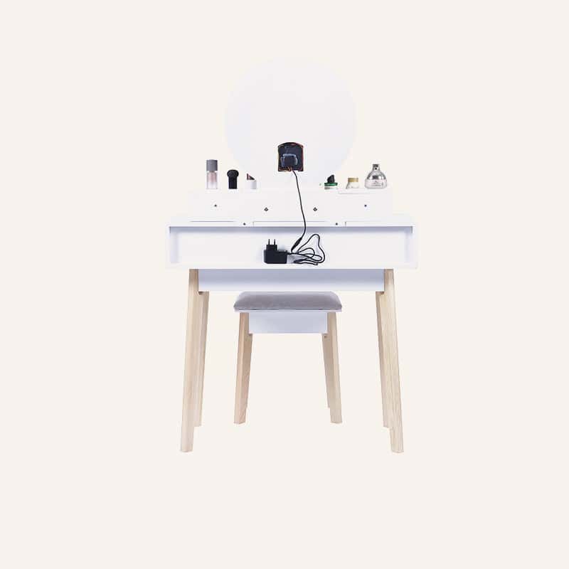 White dressing vanity table with LED mirror and makeup accessories.