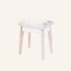 White dressing vanity stool with soft velvet cushion and wooden legs.