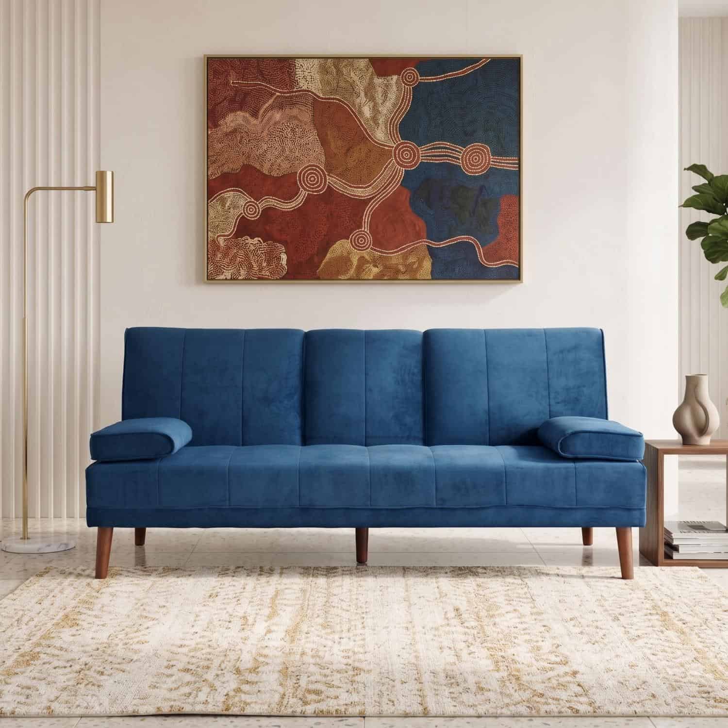 Elegant blue velvet sofa in modern living room with artwork.