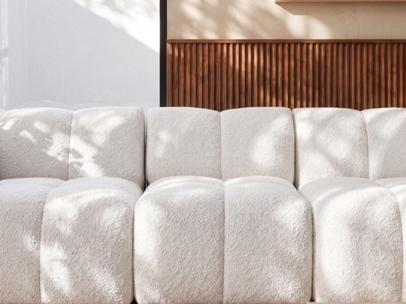 White plush sofa with textured fabric in contemporary living room.